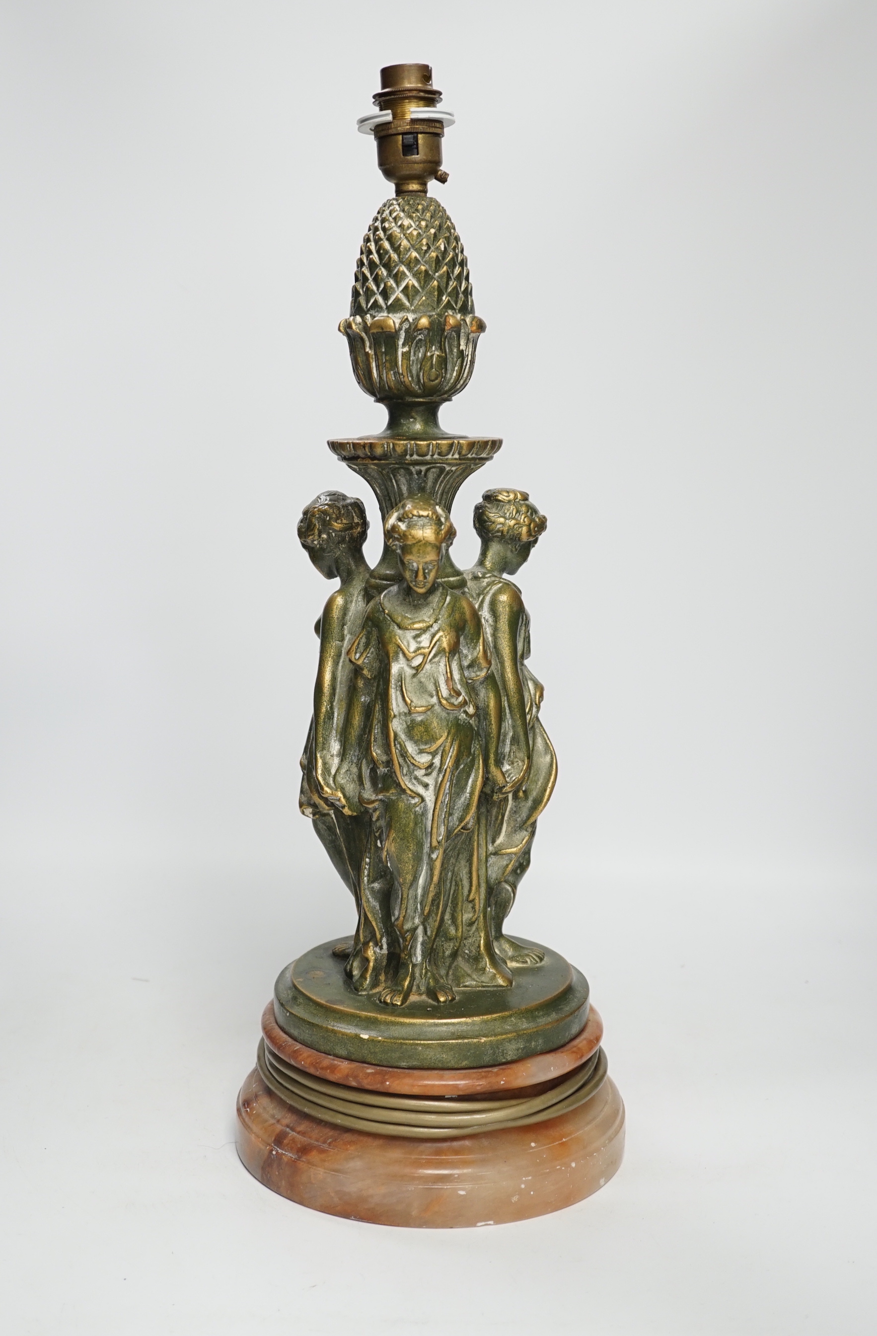 A Three Graces painted resin table lamp, partially gilded, raised on circular rouge marble base, 51cm high overall